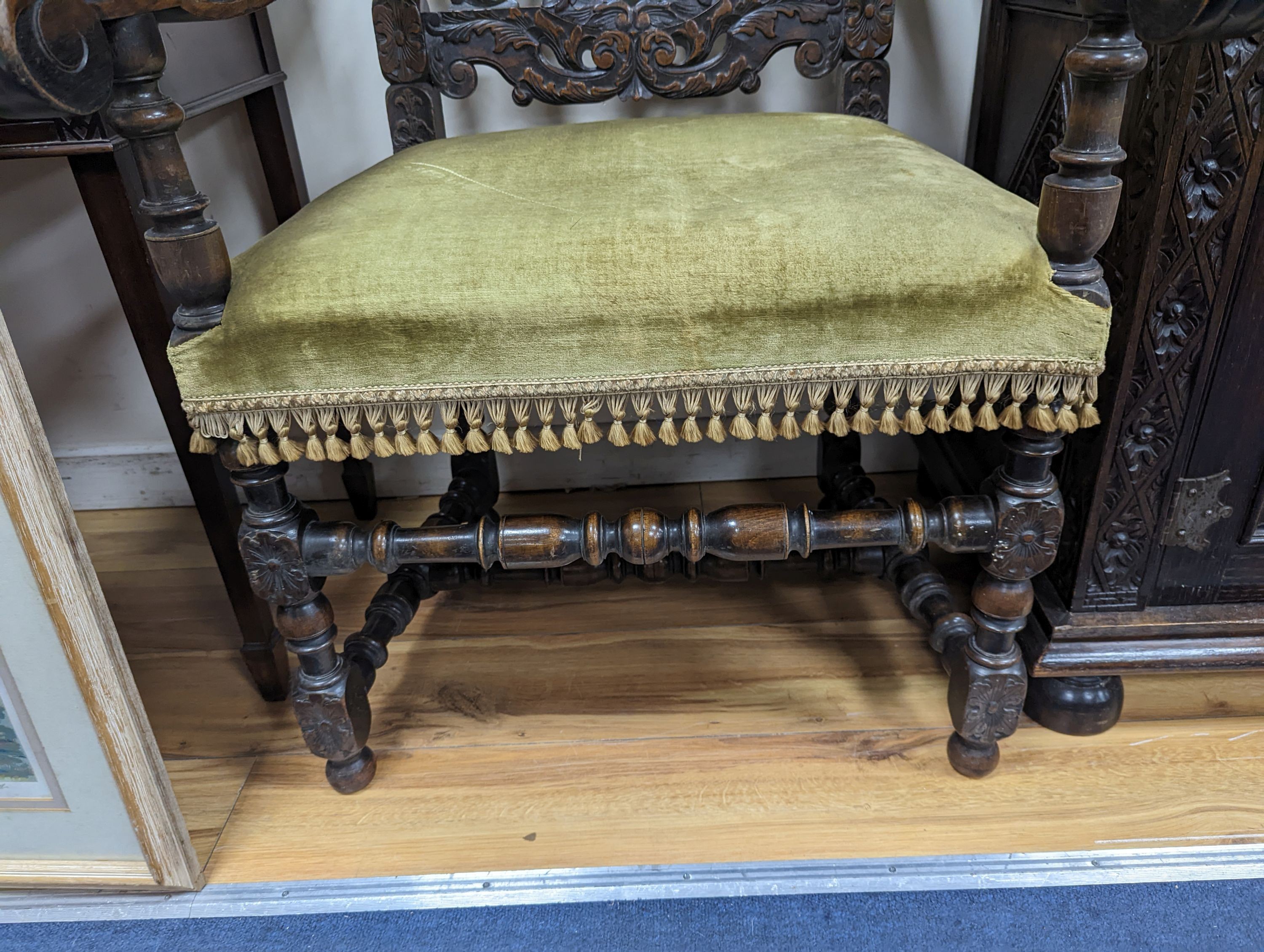 A pair Charles II style carved oak elbow chairs with upholstered seats on turned underframes, width 63cm, depth 54cm, height 133cm